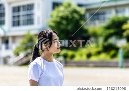 A female student gazing into the distance on the school grounds. A female student gazing into the distance on the school grounds. 138215098