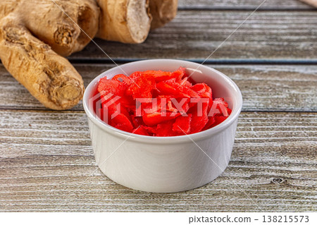 Red marinated sliced ginger roots Red marinated sliced ginger roots 138215573