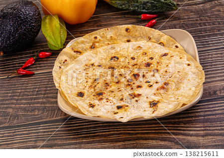 Toasted flatbread with fresh vegetables and chili peppers Toasted flatbread with fresh vegetables and chili peppers 138215611