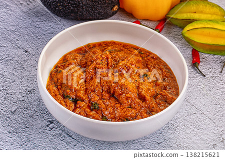 Indian butter chicken masala, a spicy traditional curry served in a bowl on a textured background. Indian butter chicken masala, a spicy traditional curry served in a bowl on a textured background. 138215621