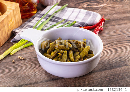 Rustic still life with a bowl of pickled gherkins, green onions, and chili peppers on a wooden table Rustic still life with a bowl of pickled gherkins, green onions, and chili peppers on a wooden table 138215641