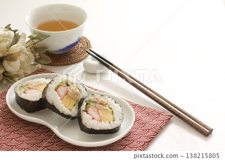 Thick sushi rolls and tea 138215805