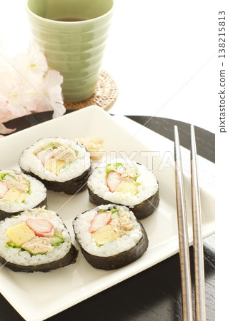 Thick sushi rolls and tea 138215813