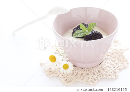 Dried prunes served in yogurt Dried prunes served in yogurt 138216135