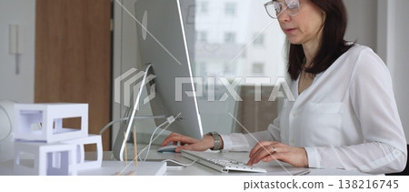 Woman architect sketching, designing, and brainstorming new building structure concepts in a modern office using computer technology. Business and architecture concept Woman architect sketching, designing, and brainstorming new building structure concepts in a modern office using computer technology. Business and architecture concept 138216745