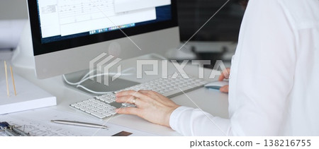 Architect woman designing building plans on computer, reviewing blueprints for architectural project development. Business and architecture concept Architect woman designing building plans on computer, reviewing blueprints for architectural project development. Business and architecture concept 138216755