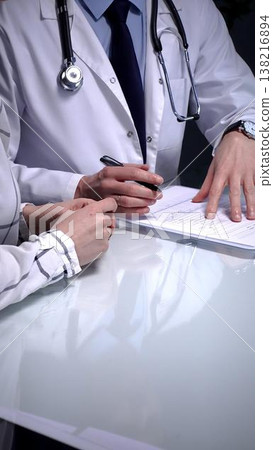 Doctor explaining medical diagnosis to a patient during a consultation, providing healthcare advice and discussing treatment options in a professional clinic setting, emphasizing health and wellness Doctor explaining medical diagnosis to a patient during a consultation, providing healthcare advice and discussing treatment options in a professional clinic setting, emphasizing health and wellness 138216894