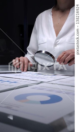Female business person working late overtime in dark office, typing on laptop with financial documents spread on desk. Audit and taxes concept Female business person working late overtime in dark office, typing on laptop with financial documents spread on desk. Audit and taxes concept 138216924