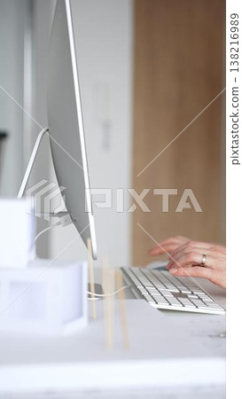 Architect working on building blueprint plans, designing new projects with computer and drawing tools. Business and architecture concept Architect working on building blueprint plans, designing new projects with computer and drawing tools. Business and architecture concept 138216989