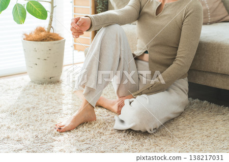 一位家庭主婦的雙腳放鬆地放在客廳沙發上(硬木地板,地暖) 一位家庭主婦的雙腳放鬆地放在客廳沙發上(硬木地板,地暖) 138217031