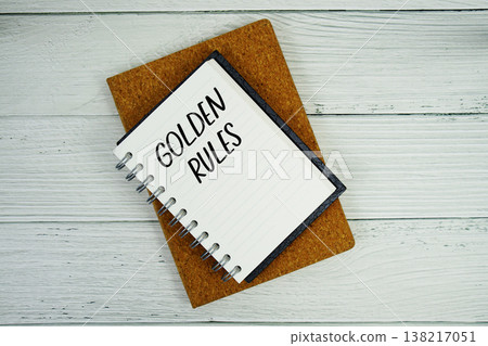 Golden Rules text written on notepad flat lay on wooden background 138217051