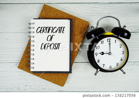 Certificate Of Deposit text written on notepad with alarm clock on wooden background 138217056