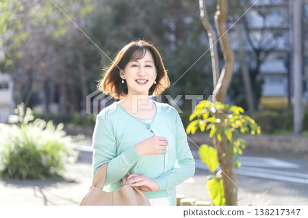 A woman in her 50s smiling at the camera A woman in her 50s smiling at the camera 138217347