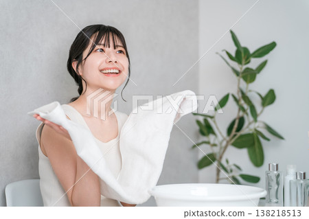 Young Asian woman washing her face and drying it with a towel (face wash) Young Asian woman washing her face and drying it with a towel (face wash) 138218513