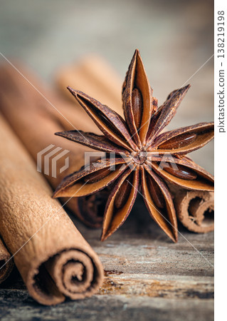 Star anise and cinnamon sticks close-up on a wooden background. Star anise and cinnamon sticks close-up on a wooden background. 138219198
