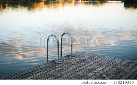 Swimming rails on the lake, wooden masonry by the river, landscape. Swimming rails on the lake, wooden masonry by the river, landscape. 138219330