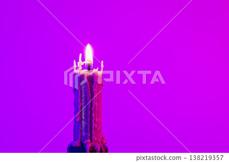 Texture vintage candle on a pink background with neon lighting, copy space. Texture vintage candle on a pink background with neon lighting, copy space. 138219357