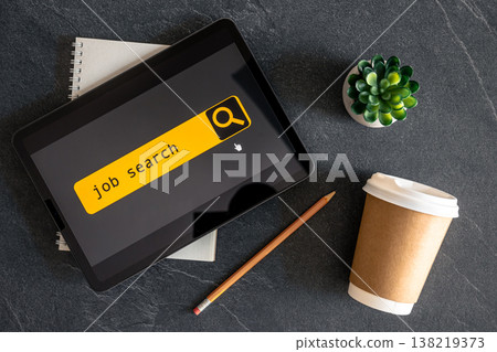 Top view of digital tablet with search job on screen. 138219373