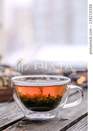 Transparent Cup of tea on wooden background Transparent Cup of tea on wooden background 138219388
