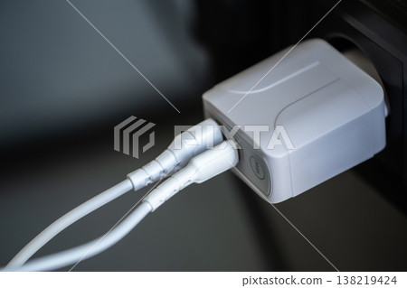 White USB charging for gadgets on a blurred background of the room, close-up. 138219424
