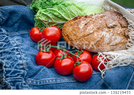 Vegetables and bread in a shopping bag, picnic concept. Vegetables and bread in a shopping bag, picnic concept. 138219455