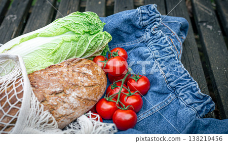 Vegetables and bread in a shopping bag, picnic concept. Vegetables and bread in a shopping bag, picnic concept. 138219456