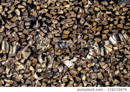 very large pile of firewood, stacked in an old barn 138219474