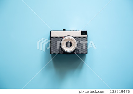 Vintage retro camera on a blue background, flat lay. Vintage retro camera on a blue background, flat lay. 138219476