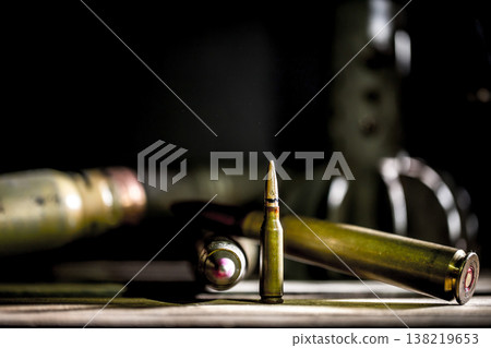 weapons, cartridge on wooden background weapons, cartridge on wooden background 138219653