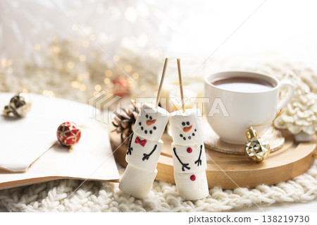 Winter composition with a cup of cocoa and marshmallows on a blurred background. Winter composition with a cup of cocoa and marshmallows on a blurred background. 138219730