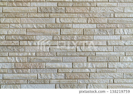 Modern stone wall texture with light beige and cream rectangular bricks. Textured surface of a contemporary architectural building facade or interior decorative tiling. Seamless background style. Modern stone wall texture with light beige and cream rectangular bricks. Textured surface of a contemporary architectural building facade or interior decorative tiling. Seamless background style. 138219759