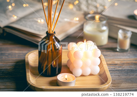 Winter spa composition with incense sticks, candles and bokeh lights. Winter spa composition with incense sticks, candles and bokeh lights. 138219774