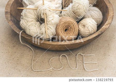 Wooden bowl with threads for knitting yarns close-up. Wooden bowl with threads for knitting yarns close-up. 138219793