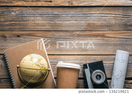 Wooden travel background with globe, map, camera and coffee, top view. 138219821