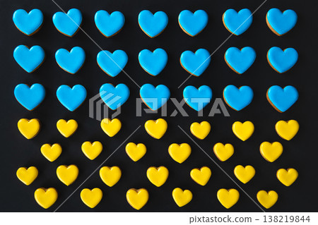 Yellow and blue handmade gingerbread cookies in the shape of hearts. Yellow and blue handmade gingerbread cookies in the shape of hearts. 138219844