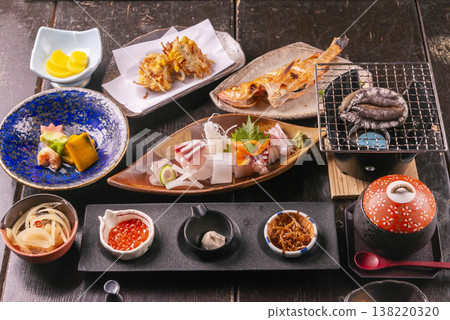 A luxurious Japanese kaiseki meal set featuring grilled dishes, sashimi, seafood, and more. A luxurious Japanese kaiseki meal set featuring grilled dishes, sashimi, seafood, and more. 138220320