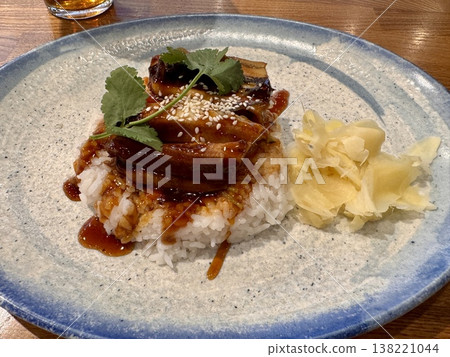 a delicious juicy dish of rice with eel in a restaurant on a beautiful plate 138221044