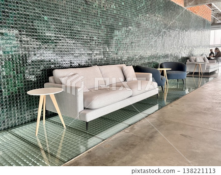 a modern leather sofa in a pastel beige shade in a stylish interior a modern leather sofa in a pastel beige shade in a stylish interior 138221113