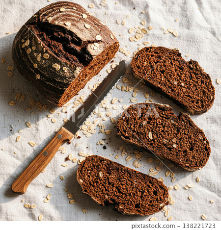 Whole and sliced chocolate rye bread with knife Whole and sliced chocolate rye bread with knife 138221723