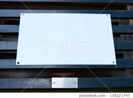 Blank empty white rectangle nameplate sign on dark metal surface Blank empty white rectangle nameplate sign on dark metal surface 138221747