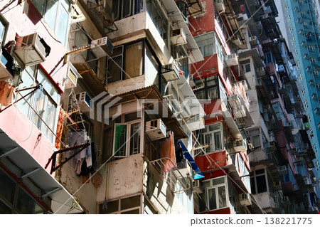 old crowded residential apartment building facades with air conditioners in Hong Kong 138221775