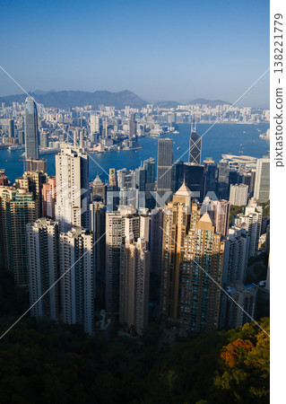 Wide panoramic daytime view of Hong Kong island dense skyscraper skyline and harbour from Victoria Peak Wide panoramic daytime view of Hong Kong island dense skyscraper skyline and harbour from Victoria Peak 138221779