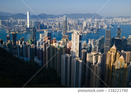 Wide panoramic daytime view of Hong Kong island dense skyscraper skyline and harbour from Victoria Peak Wide panoramic daytime view of Hong Kong island dense skyscraper skyline and harbour from Victoria Peak 138221780