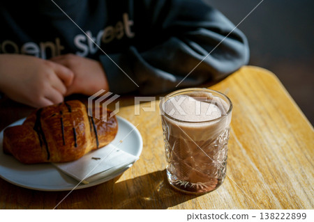 Hot chocolate with croissant and person in cafe, cozy morning breakfast, lifestyle scene, relaxing coffee shop atmosphere, comfort and leisure concept Hot chocolate with croissant and person in cafe, cozy morning breakfast, lifestyle scene, relaxing coffee shop atmosphere, comfort and leisure concept 138222899