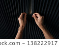 Cropped shot of professional arranging dark acoustic foam panels on a wall, installing soundproofing material for noise reduction in a creative studio or home environment. 138222917
