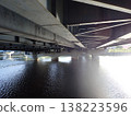 A full view of the underside of a road bridge (steel bridge) spanning an urban river. 138223596