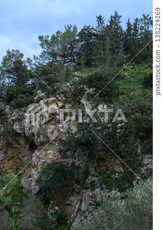 Adventurous hikers exploring rugged terrain under a cloudy sky in a serene mountainous region during the early morning hours Adventurous hikers exploring rugged terrain under a cloudy sky in a serene mountainous region during the early morning hours 138224269