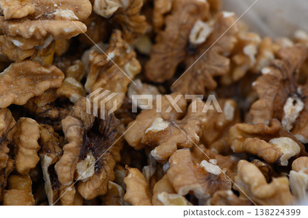 Delicate walnut halves showcase rich textures and earthy tones in a bountiful display ready for culinary delights Delicate walnut halves showcase rich textures and earthy tones in a bountiful display ready for culinary delights 138224399