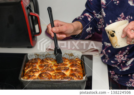 Baking golden rolls in a cozy kitchen while sipping warm coffee and enjoying the aroma of fresh bread Baking golden rolls in a cozy kitchen while sipping warm coffee and enjoying the aroma of fresh bread 138224506