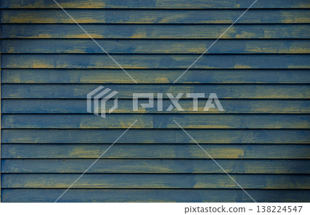 Textured wooden wall showcases vibrant blue and yellow brush strokes in artistic allure of creative design 138224547
